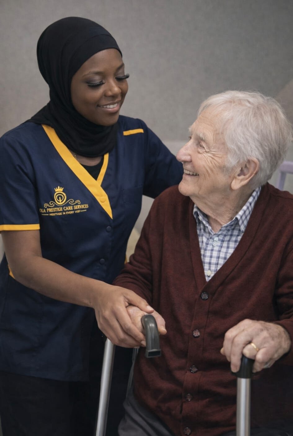 Caregiver assisting elderly person with walker.