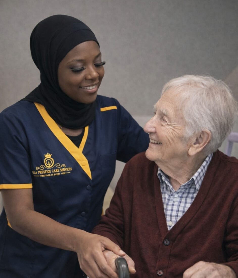 Caregiver assisting elderly person with walker.